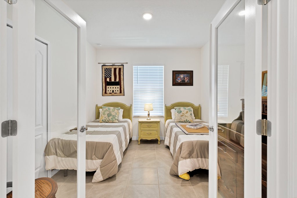 6035 Red Maple Manor Vero Beach, FL 32966 - Photo 21 of 36 a bedroom with two beds and painted walls