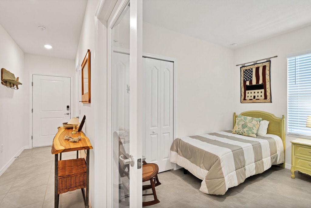 6035 Red Maple Manor Vero Beach, FL 32966 - Photo 22 of 36 a bedroom with a bed and a painting on the wall