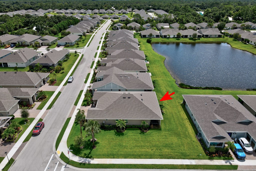 6035 Red Maple Manor Vero Beach, FL 32966 - Photo 30 of 36 an aerial view of a house with a yard and lake view