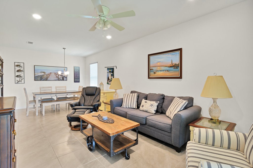 6035 Red Maple Manor Vero Beach, FL 32966 - Photo 8 of 36 a living room with furniture and a lamp
