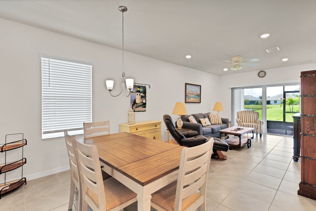 6035 Red Maple Manor Vero Beach, FL 32966 - Photo 9 of 36 a living room with furniture a window and a table
