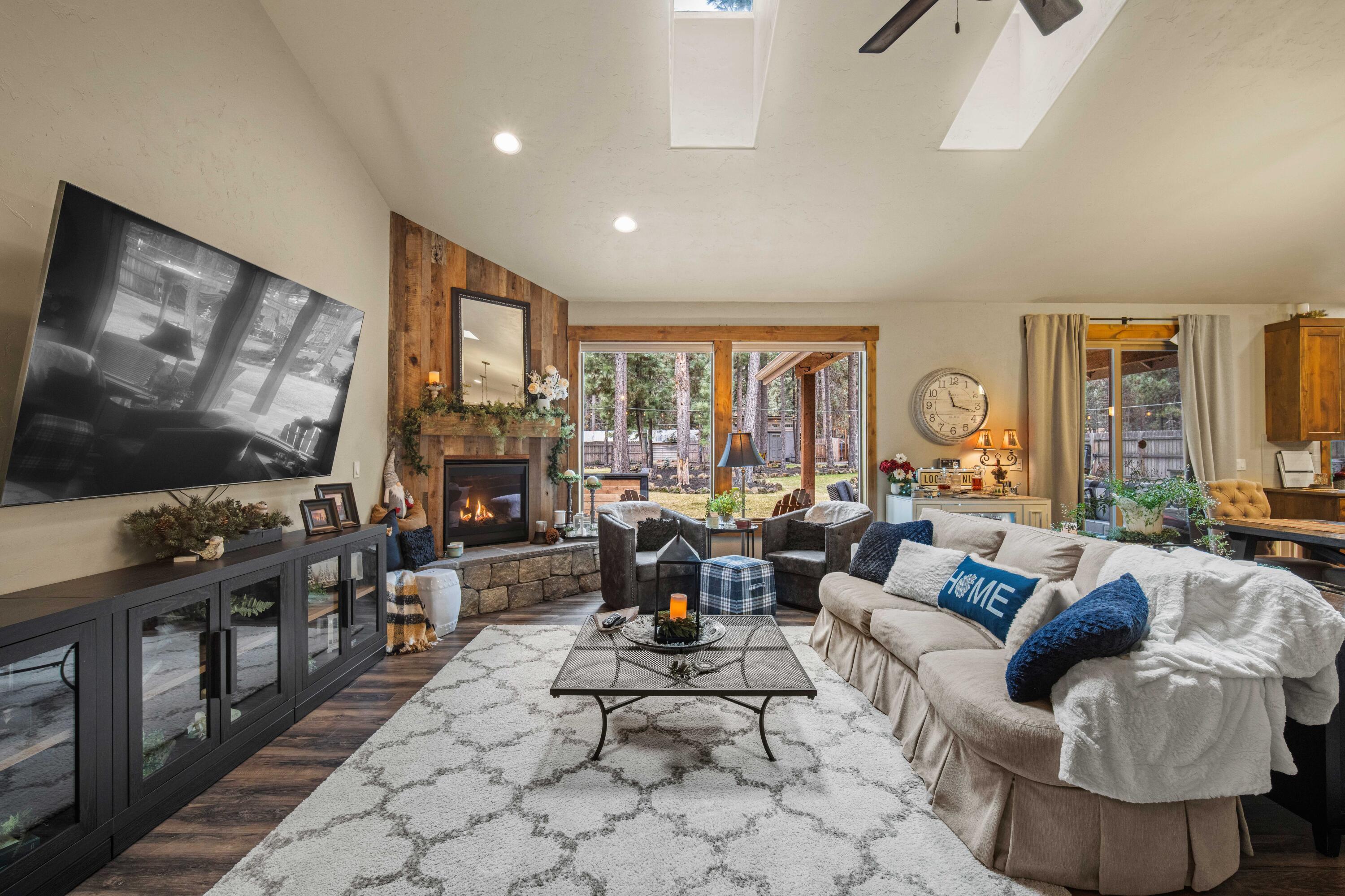 16927 Covina Road Bend, OR 97707 - Photo 6 of 54 Open great room with fireplace, soaring ceilings, and a seamless connection to the peaceful, park-like backyard setting.