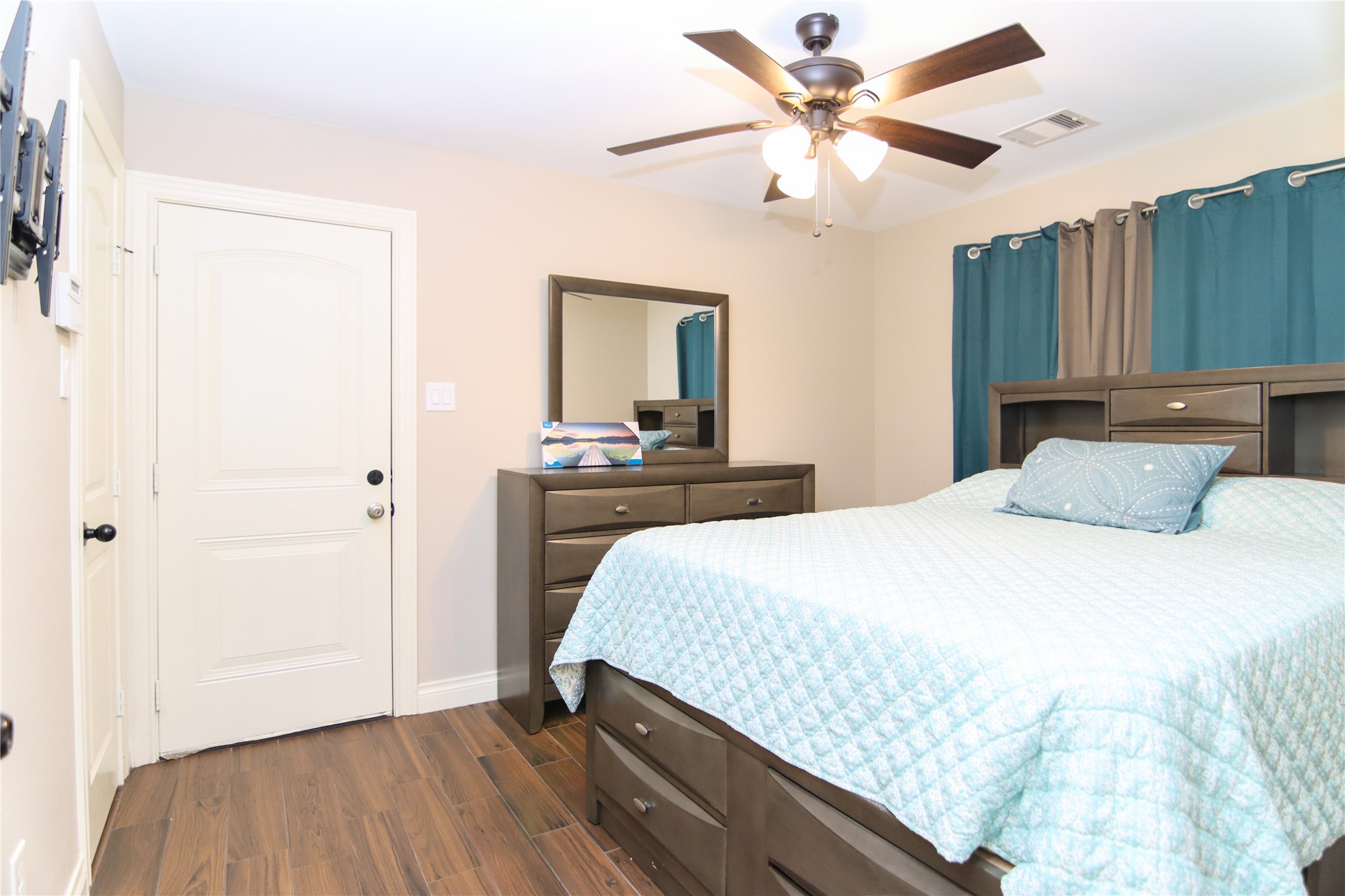 9710 Wind Flower Lane Houston, TX 77086 - Photo 13 of 21 a bedroom with a bed and a chandelier