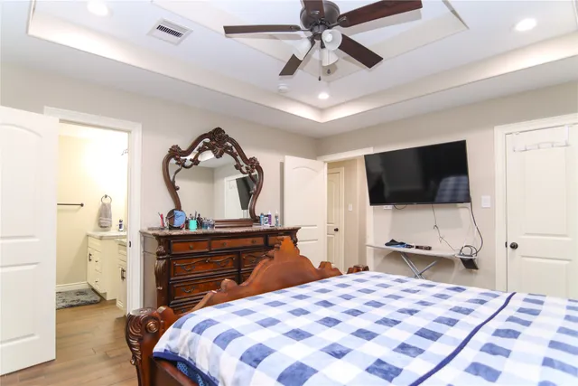 a bedroom with a bed and a flat screen tv