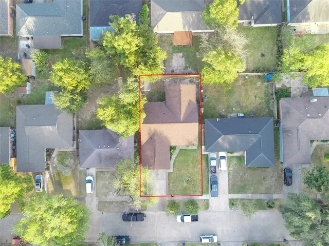 an aerial view of multiple houses with a yard