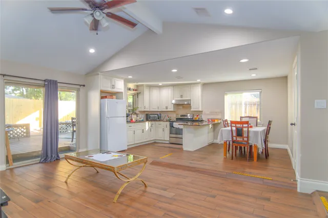 a living room with dining room and wooden floor
