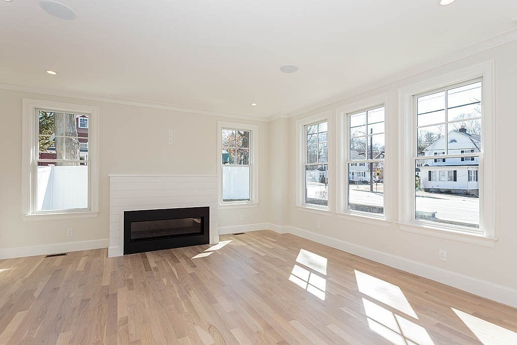 258 Reedsdale Road Milton, MA 02186 - Photo 12 of 34 a view of empty room with a fireplace and windows