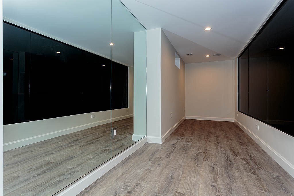 258 Reedsdale Road Milton, MA 02186 - Photo 30 of 34 a view of an empty room with wooden floor and a window