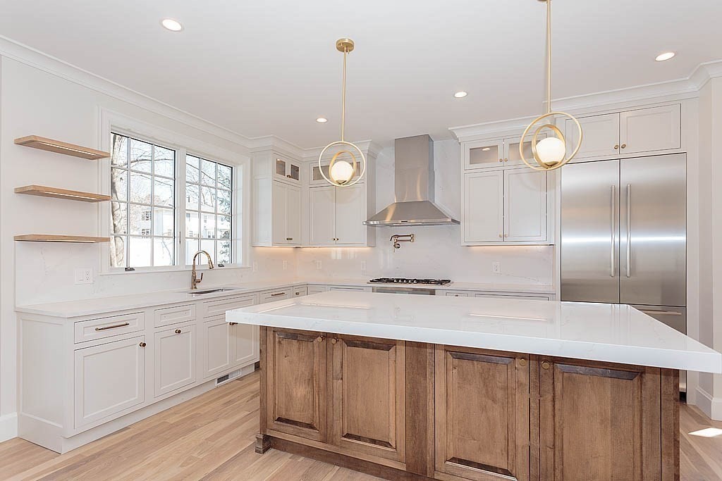 258 Reedsdale Road Milton, MA 02186 - Photo 4 of 34 a kitchen with kitchen island granite countertop a sink a counter space and stainless steel appliances