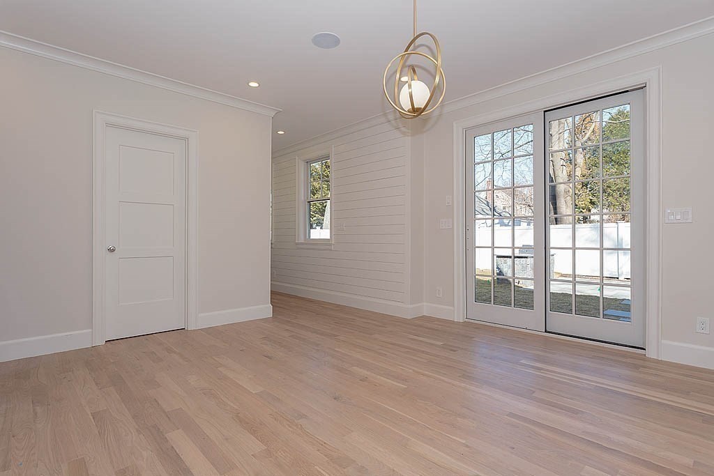 258 Reedsdale Road Milton, MA 02186 - Photo 8 of 34 an empty room with wooden floor and windows