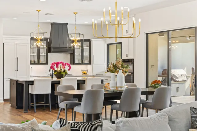 a view of a dining room with furniture and a chandelier