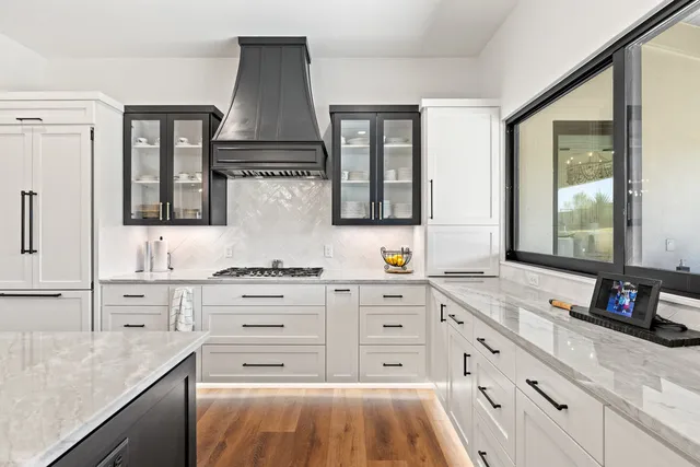 a kitchen with stainless steel appliances a stove sink and cabinets