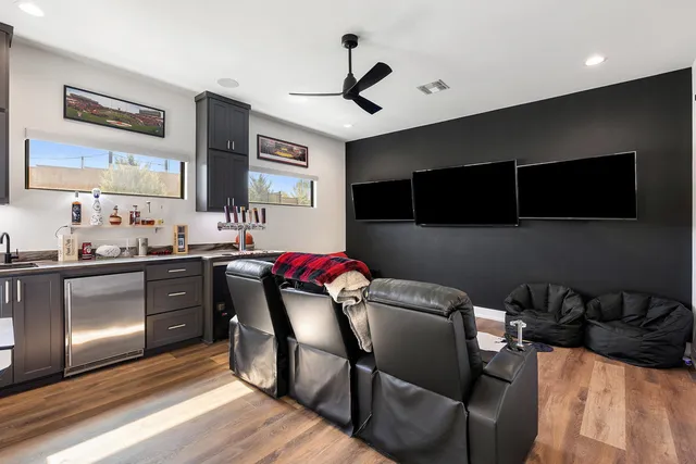 a kitchen with stainless steel appliances granite countertop a stove a sink dishwasher and a microwave with wooden floor