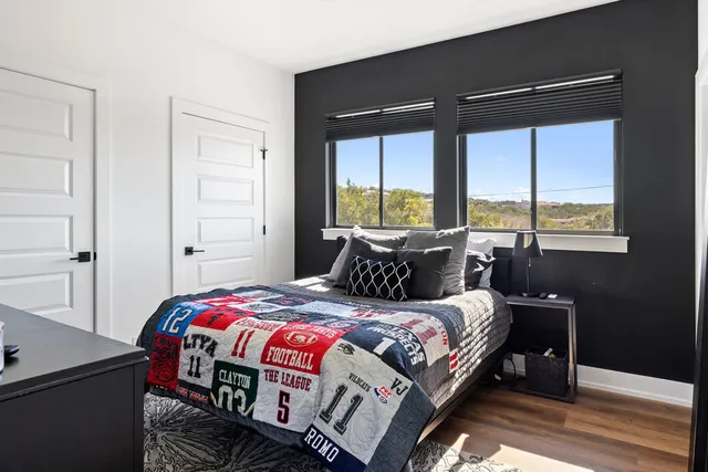 a bedroom with a bed and a window