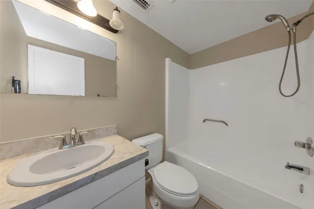 a bathroom with a toilet sink shower and mirror