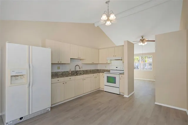 a kitchen with stainless steel appliances a white cabinets and sink