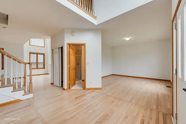 an empty room with wooden floor and a window