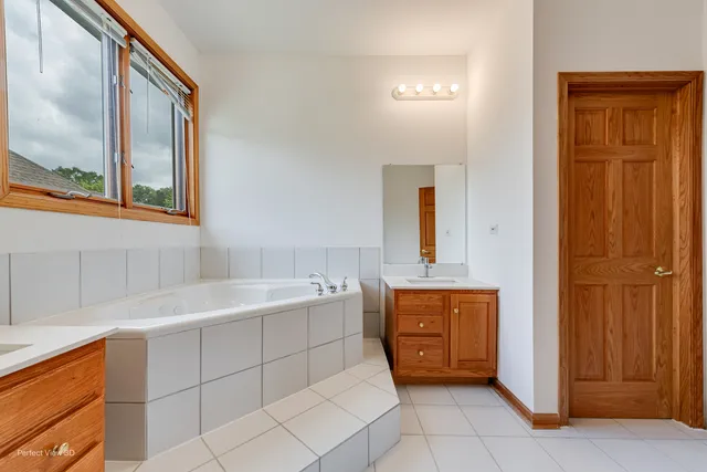 a bathroom with a sink double vanity and a mirror