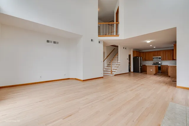 a view of a kitchen with a sink and a refrigerator