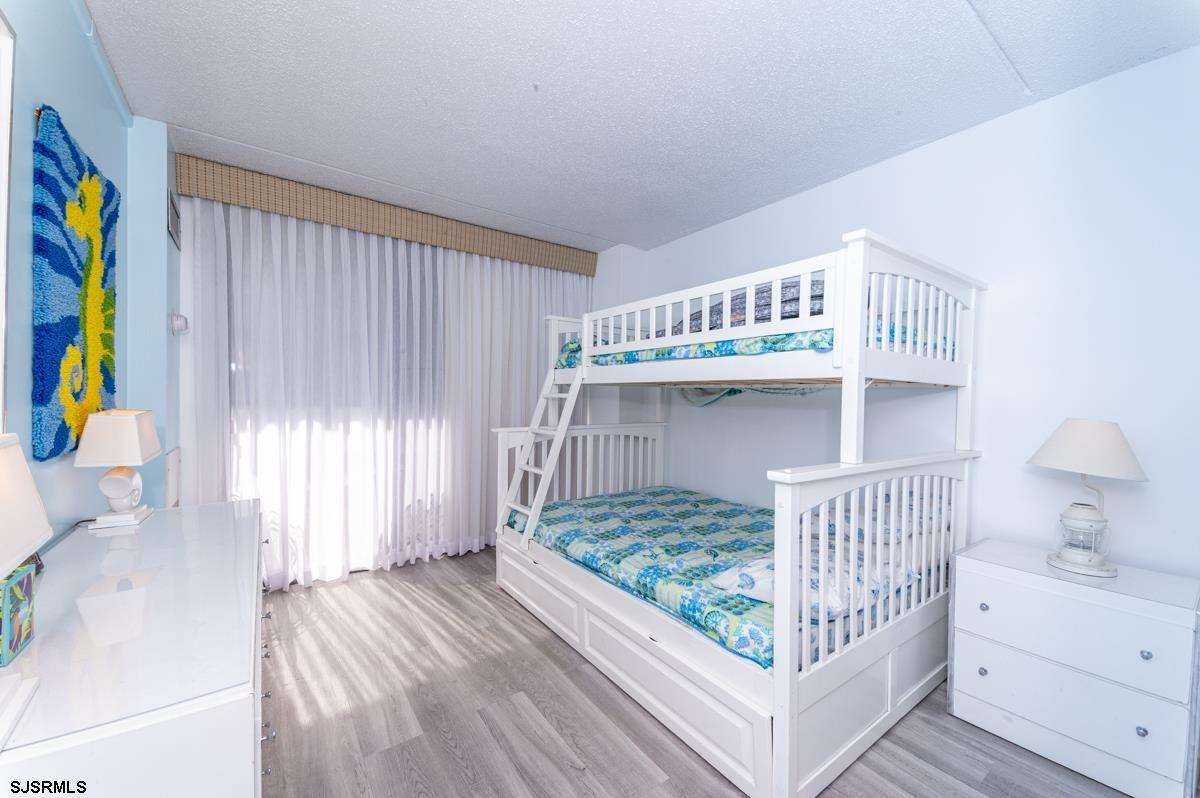 935 Ocean Avenue, Unit 315 Ocean City, NJ 08226 - Photo 14 of 37 a bedroom with a bed and a window