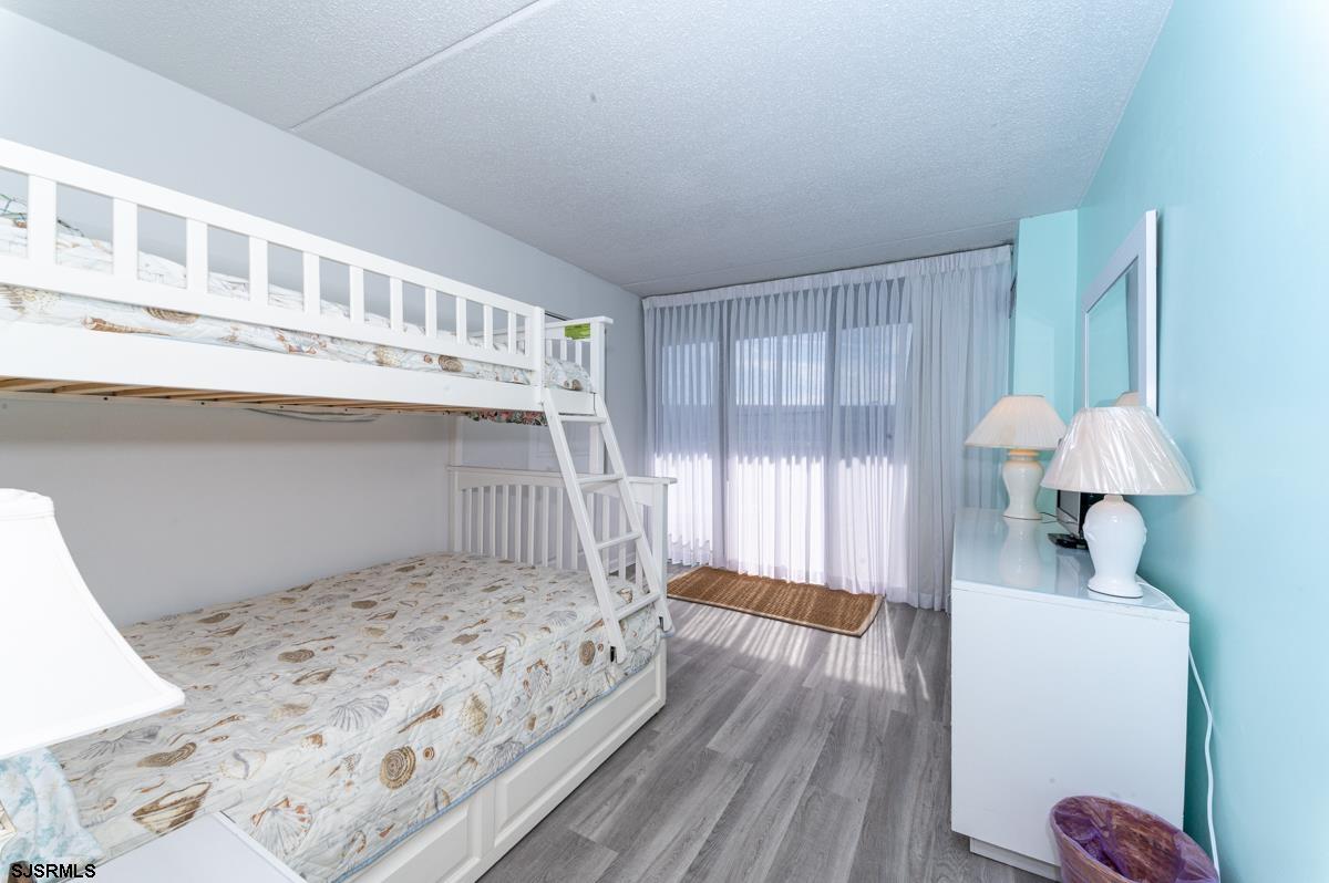 935 Ocean Avenue, Unit 315 Ocean City, NJ 08226 - Photo 16 of 37 a bedroom with a bed and a window