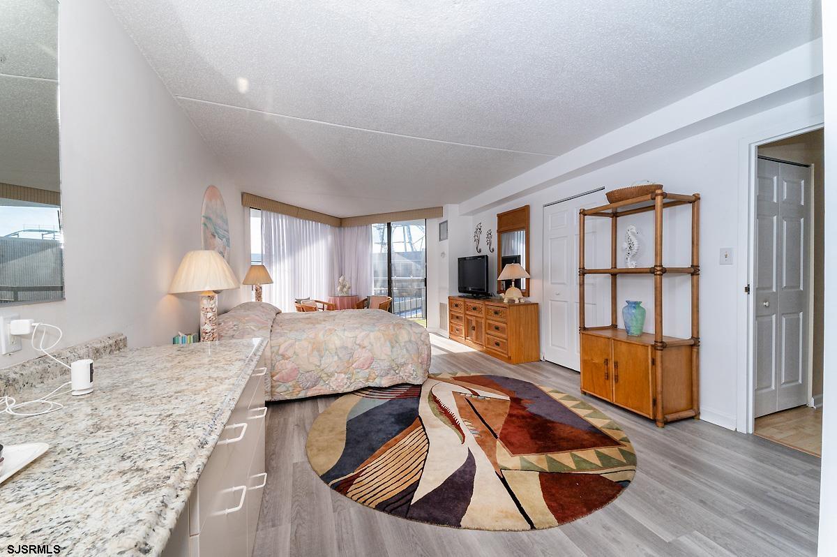 935 Ocean Avenue, Unit 315 Ocean City, NJ 08226 - Photo 19 of 37 a living room with furniture and a wooden floor