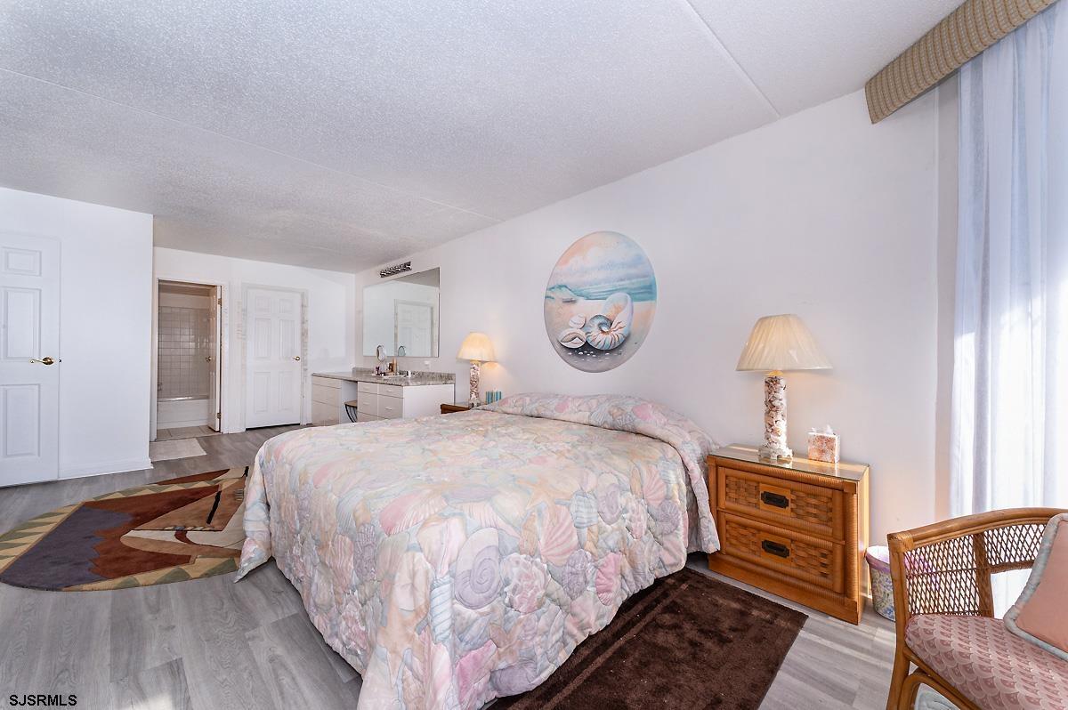 935 Ocean Avenue, Unit 315 Ocean City, NJ 08226 - Photo 20 of 37 a bedroom with bed and a window