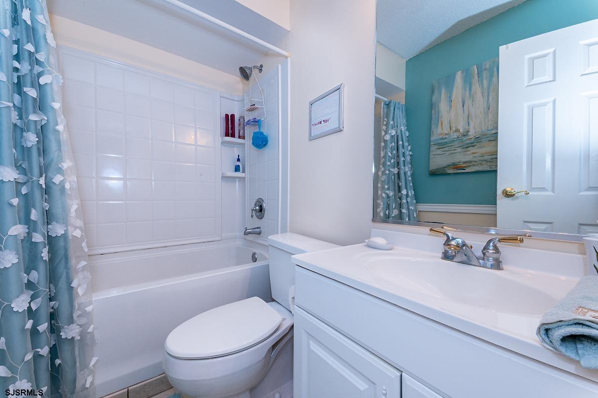 935 Ocean Avenue, Unit 315 Ocean City, NJ 08226 - Photo 25 of 37 a bathroom with a sink a toilet and shower