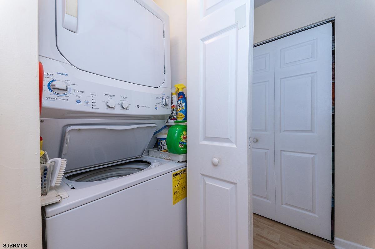 935 Ocean Avenue, Unit 315 Ocean City, NJ 08226 - Photo 26 of 37 a living room with a fireplace furniture and a potted plant