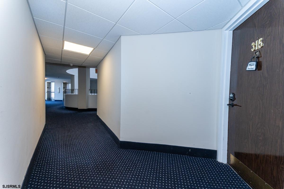 935 Ocean Avenue, Unit 315 Ocean City, NJ 08226 - Photo 27 of 37 a view of hallway with wooden floor