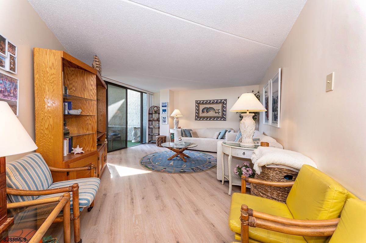935 Ocean Avenue, Unit 315 Ocean City, NJ 08226 - Photo 3 of 37 a living room with furniture and a wooden floor