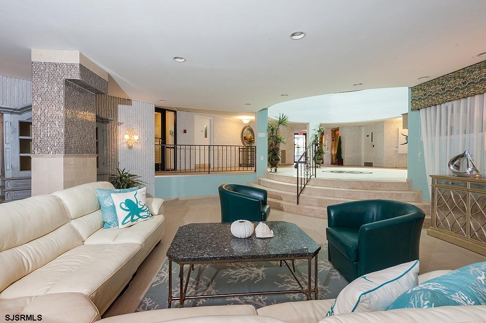 935 Ocean Avenue, Unit 315 Ocean City, NJ 08226 - Photo 35 of 37 a living room with furniture and a potted plant