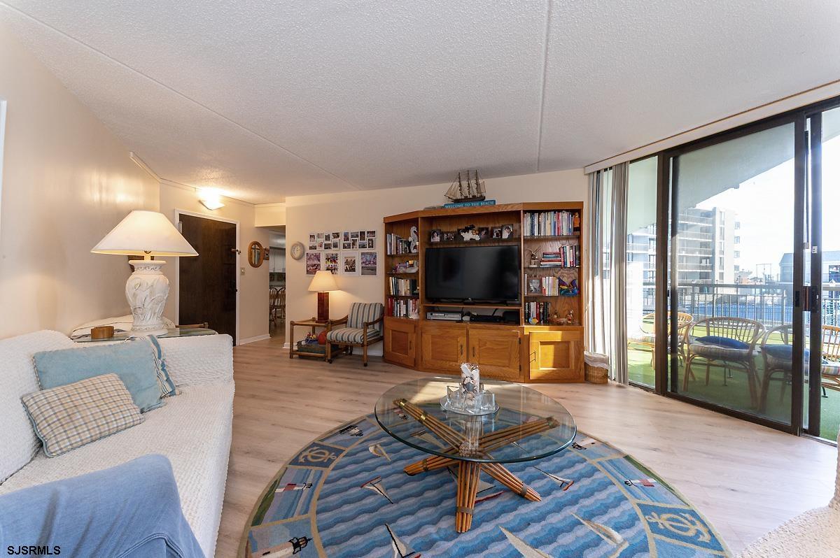 935 Ocean Avenue, Unit 315 Ocean City, NJ 08226 - Photo 4 of 37 a living room with furniture and a flat screen tv