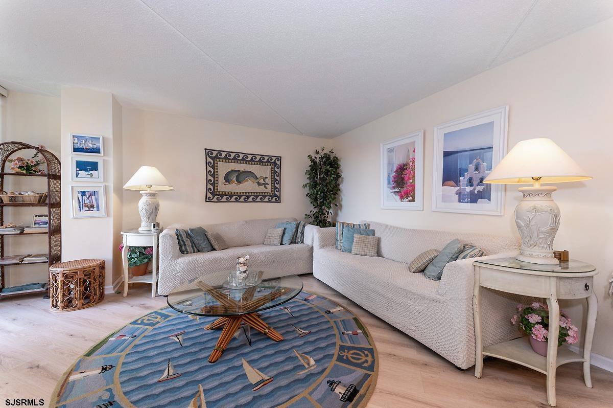 935 Ocean Avenue, Unit 315 Ocean City, NJ 08226 - Photo 5 of 37 a living room with furniture and a lamp