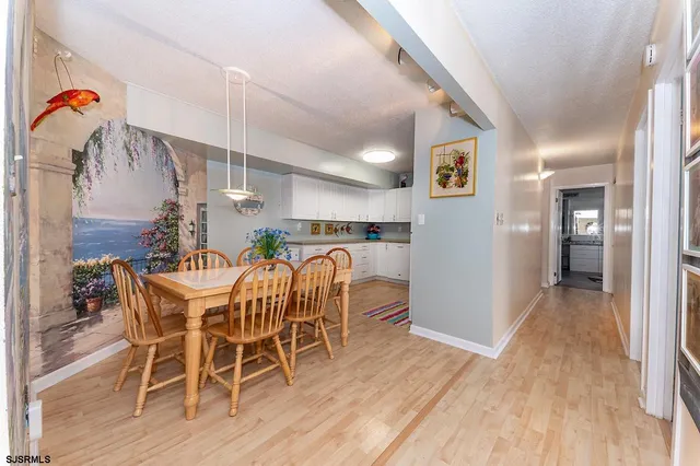 a dining room with furniture and wooden floor