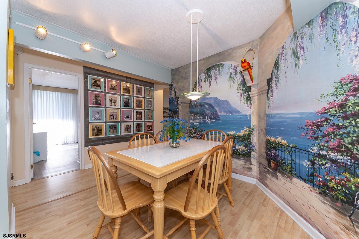 935 Ocean Avenue, Unit 315 Ocean City, NJ 08226 - Photo 8 of 37 a view of a dining room with furniture and wooden floor