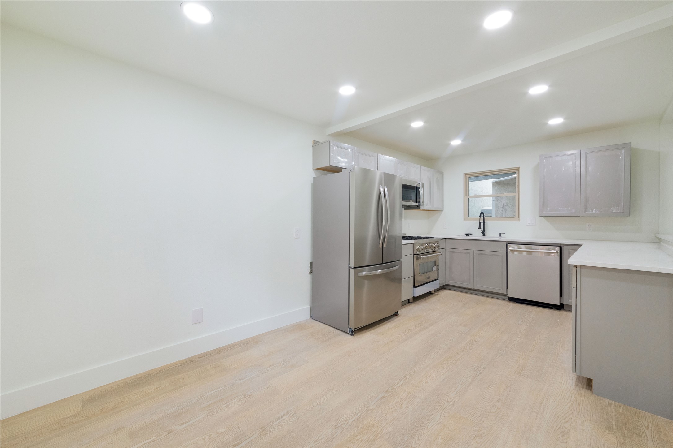 8807 Merion Circle Austin, TX 78754 - Photo 5 of 18 A well-appointed culinary space featuring sleek stainless steel appliances and light wood flooring.