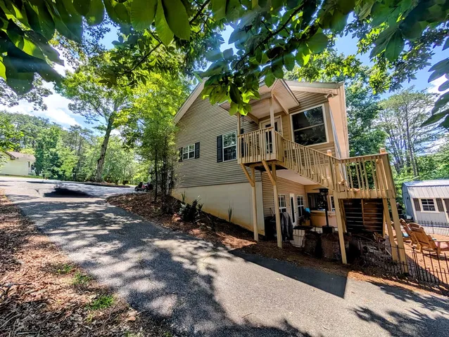 a view of a house with backyard and sitting area