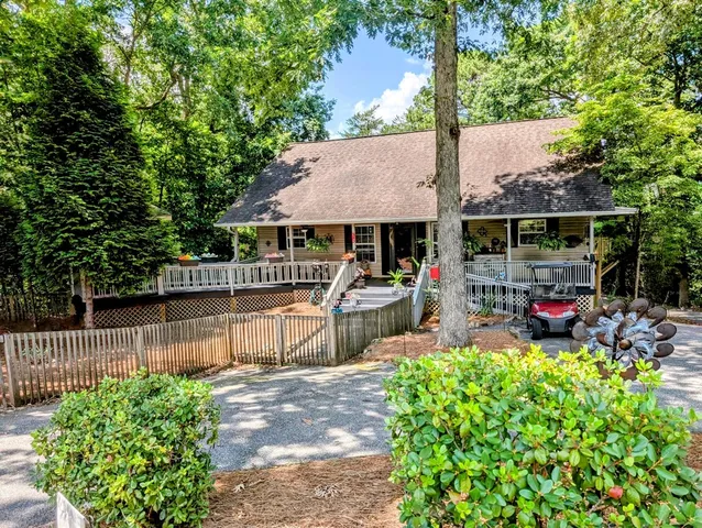a view of a house with a patio and a yard