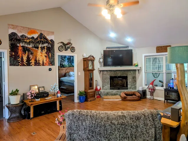 a living room with furniture and a floor to ceiling window
