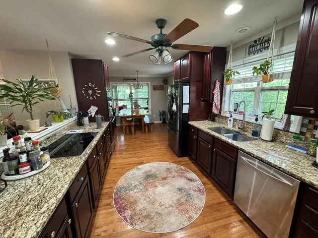 a living room with furniture flowerpot and wooden floor