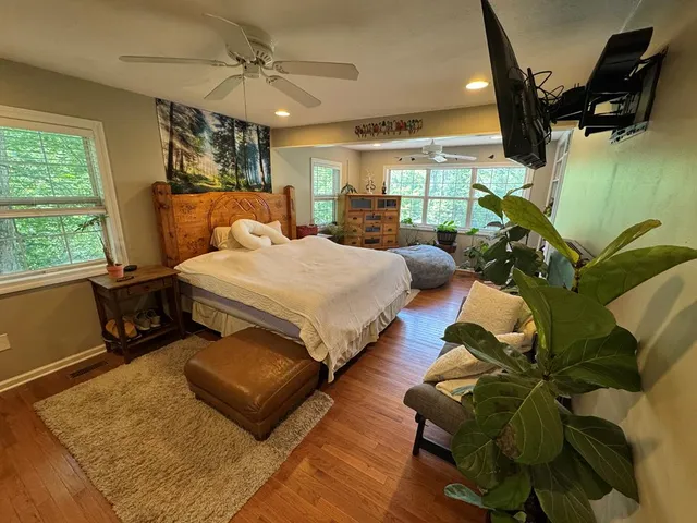 a living room with furniture and a wooden floor