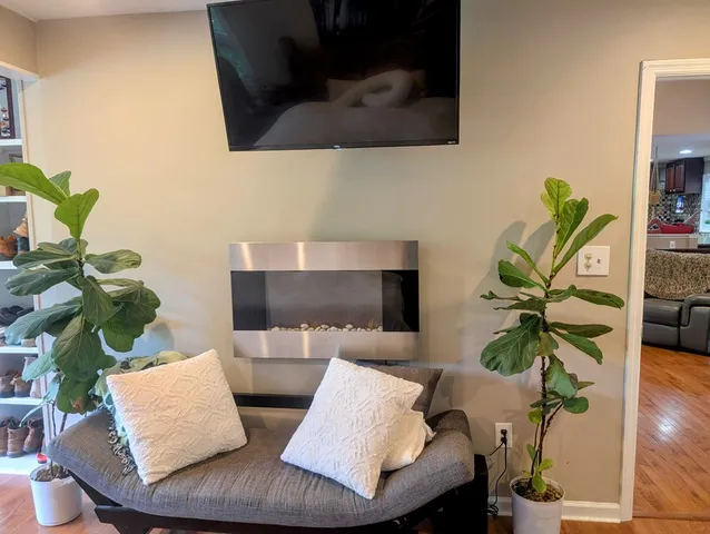 a living room with furniture and a floor to ceiling window