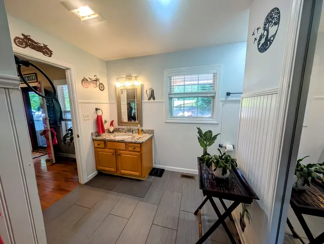 a view of a wooden house with large trees