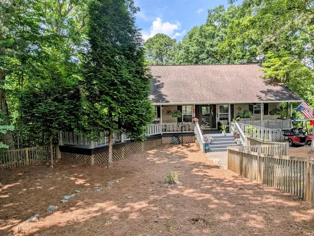 a view of a house with sitting area and garden