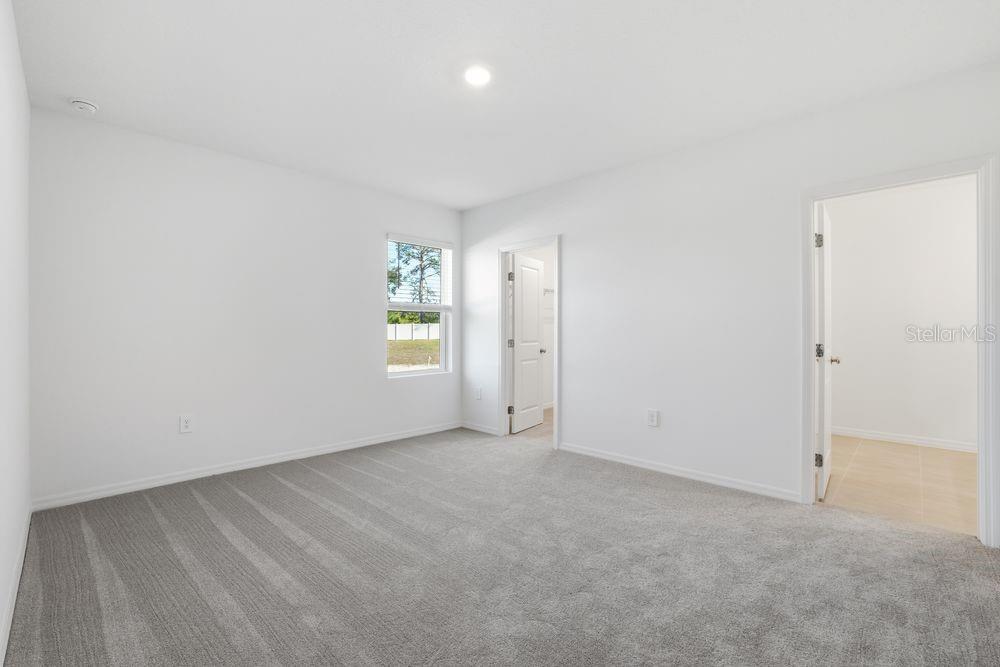 13640 Tropical Breeze Way Hudson, FL 34669 - Photo 14 of 48 an empty room with windows and closet