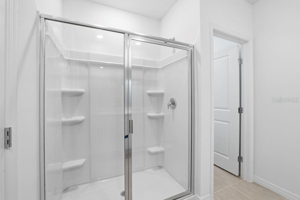 13640 Tropical Breeze Way Hudson, FL 34669 - Photo 17 of 48 a bathroom with a shower and toilet