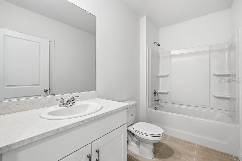 13640 Tropical Breeze Way Hudson, FL 34669 - Photo 27 of 48 a bathroom with a sink toilet vanity and shower