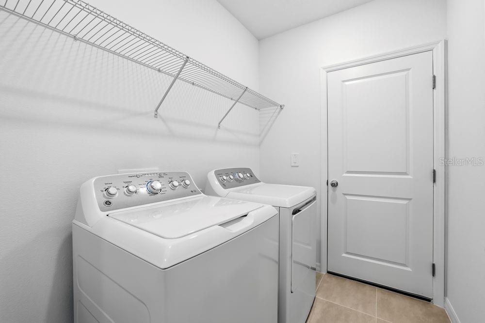 13640 Tropical Breeze Way Hudson, FL 34669 - Photo 30 of 48 a utility room with dryer and washer