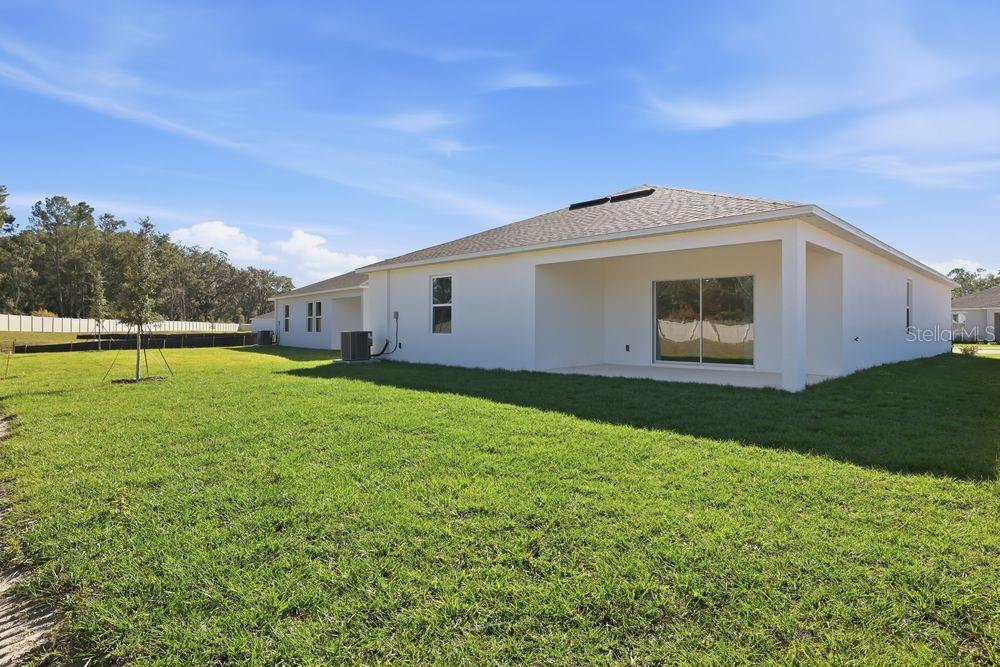 13640 Tropical Breeze Way Hudson, FL 34669 - Photo 34 of 48 a front view of a house with garden